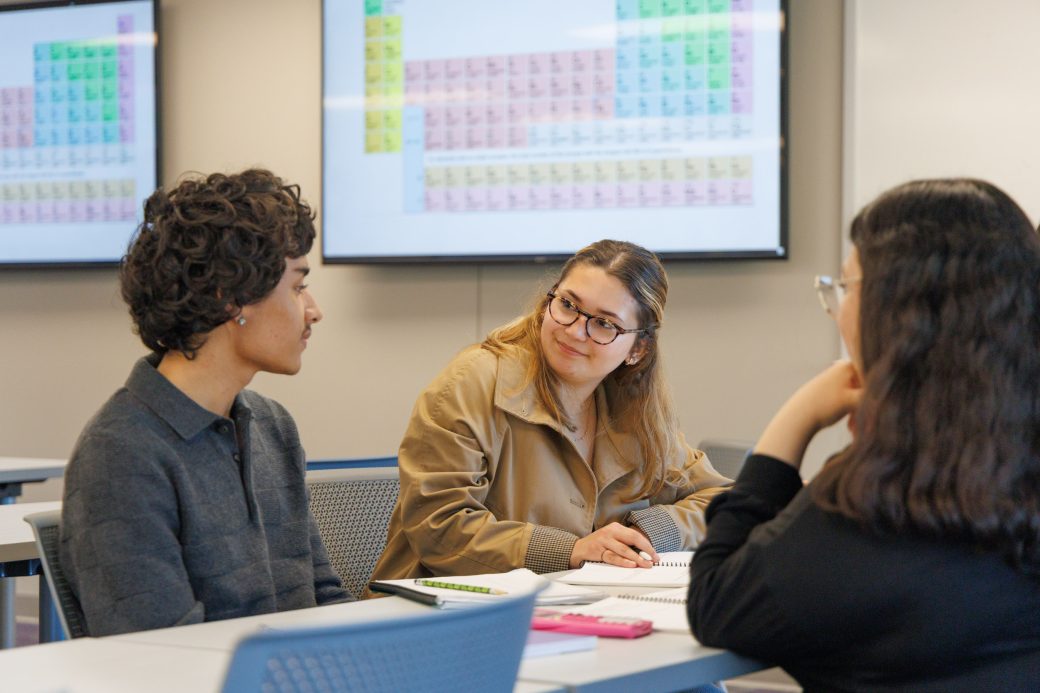 Students having a conversation in a chemistry class