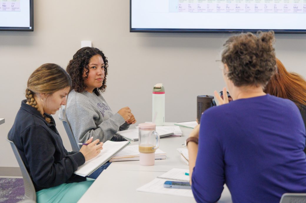 ASL translator communicating with student in chemistry class