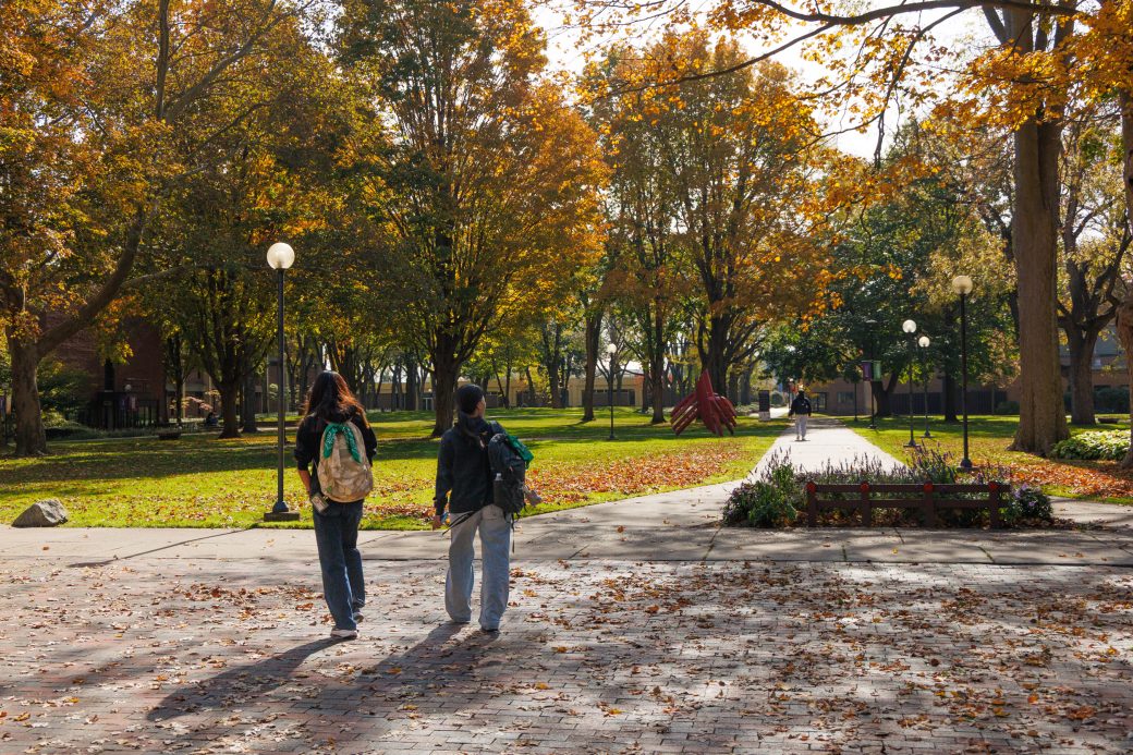 Students walking through campus in fall