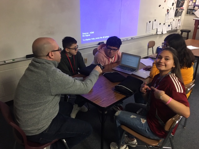 Middle grade students working at a rectangle table