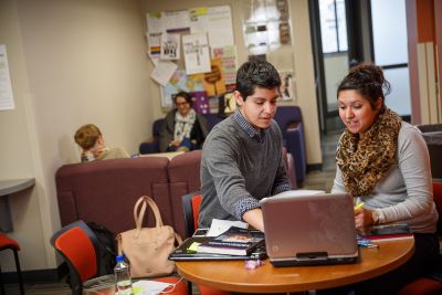 Students doing schoolwork in a campus space at Goshen, one of top-ranked liberal art schools for value