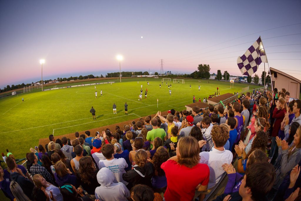 Collegiate athletic at Goshen include soccer teams, shown here being supported by other students