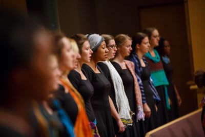 A group of Goshen College students singing during campus celebration.