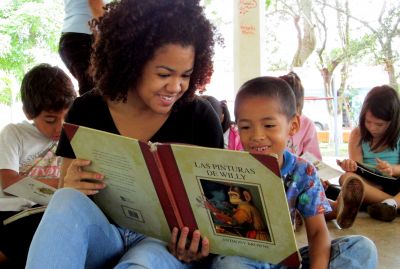 Cora reads a story to one of the boys.