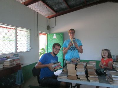 Wade and Erin organizing books in the library.