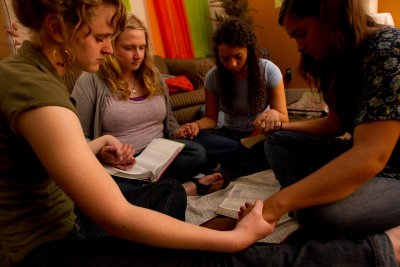 Students praying during bible study