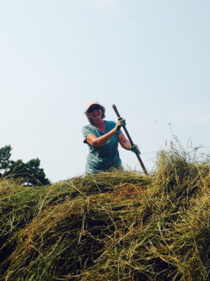 Andy Meyers atop a pile of hay