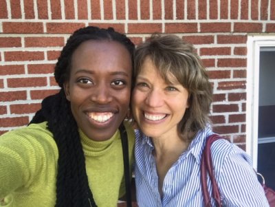 Two women standing next to each other smiling