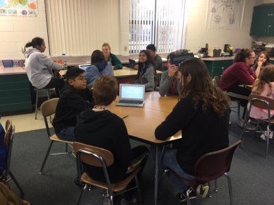 Middle School students working in a classroom at a hexagon table