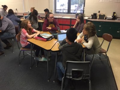 Middle Grade Students working at a hexagon table