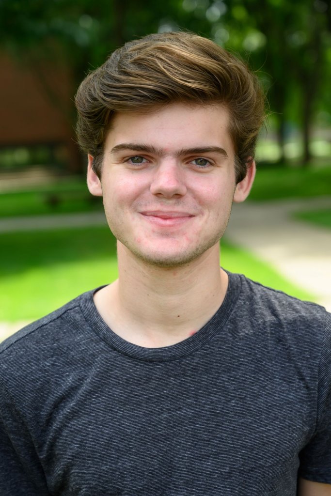 Man in a gray t-shirt smiling