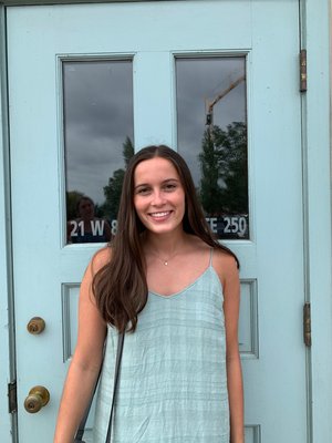 Photo of Suzanna Yoder in front of blue door.