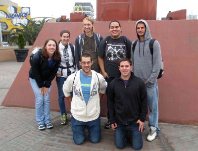 Goshen College students pause in Ovalo Gutierrez for a group photograph. Ovalo Gutierrez,  a large traffic circle surrounded by businesses, is a center of commercial life in the Miraflores and San Isidro districts of Lima.