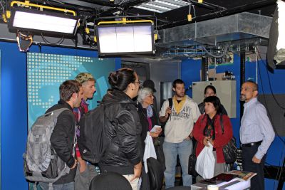 GC students listen to a news producer in an RPP television studio.