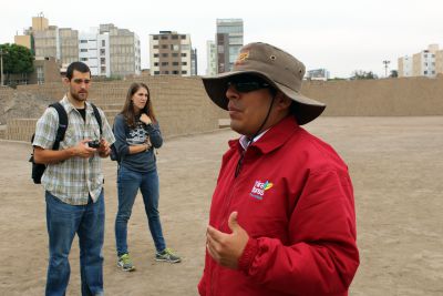 Rudy and Lauren listen as a tour guide explains the history of Huaca Pucllana.