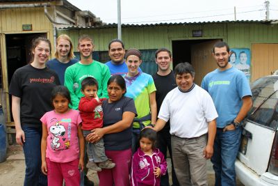 Becca, Landon, Alan, Jacob, Lauren, Joshua and Rudy pause for a photo with Corpusa Villavicencio Zela, three of her four children, and her brother, Willy Villavicencio, Goshen College's service coordinator in Peru.