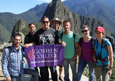 Rudy, Joshua, Jacob, Landon, Alan, Becca and Lauren unfurl a Goshen College banner at Machu Picchu.