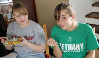 Aimee and Gina try to eat despite the presence of a persistent photographer.