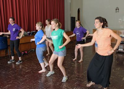 The women learn a new dance.