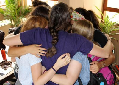 Goshen women say goodbye with a group hug.