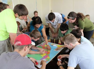 Lima Study Coordinator Celia Vasquez helps students find the locations of their service assignments. 