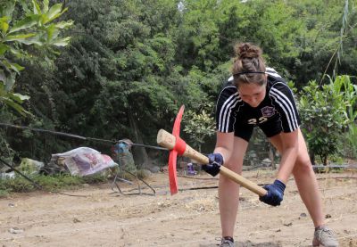 Malaina turns over the soil.