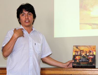 Andrés Francisco Paredes Salgado shows off Guerra en el Pacifico, a strategy board game he invented.