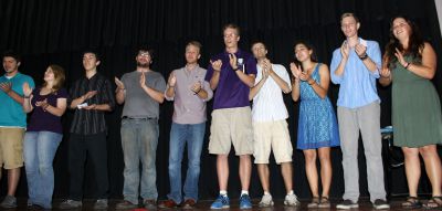 Students sing for and applaud their host families.