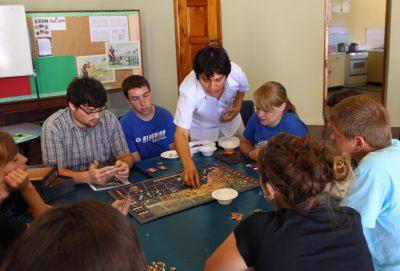 Andres provides guidance to students for playing Guerra en el Pacifico.