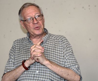 Father Klaiber makes a point using a gesture that resembles hands held in prayer.