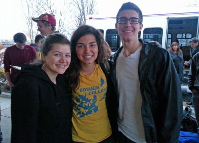 Gretchen (center) reunites with friends after returning to Goshen College from Peru SST. Behind her, in the red cap, is Thomas, who was also part of the Peru SST unit. Chatting by the bus are Director of International Education Tom Meyers and Chris Kennel, his administrative assistant. 