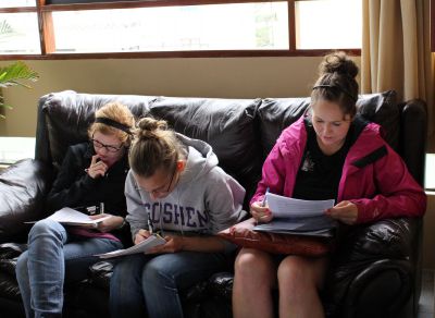 Natalie Gina and Maina complete some survey forms.