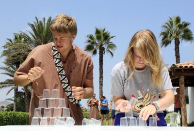 Recreating a popular Peruvian TV show, Derek and Aimee compete to see who can stack cups the fastest.