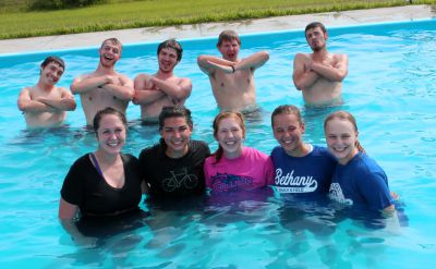 Goshen men and women strike decidedly different poses in the pool.