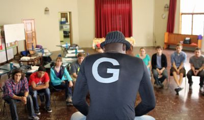 Camilo Ballumbrosio shows students how to play the cajón. 