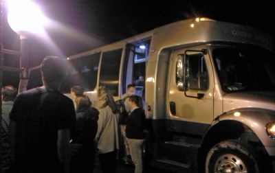 Students prepare to depart for O'Hare International Airport in Goshen College's bus.