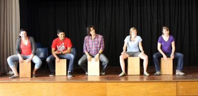 Jamie, Alejandro, Lucas, Emma and Leah learn how to play the cajón. 