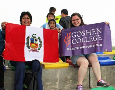 Holding symbols of Peru and Goshen College are Miranda and Livia Salas Achahuanco, host mother of Alejandro.