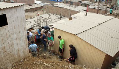 Students begin clearing rocks beside the tiny Anglican mission.