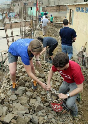 Emma and Brody remove rocks.