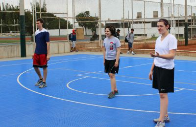 Joel, Edith and Jaime prepare to return a serve.