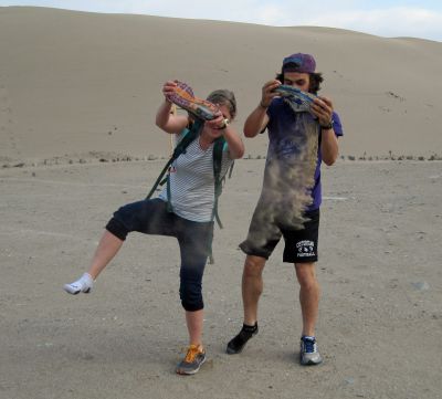 Emma and Lucas shake out ancient sand from their shoes.