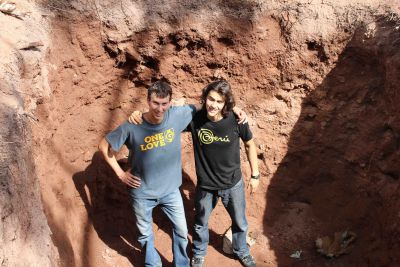 Lucas and Joel inside a huge septic pit they helped dig.