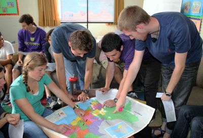 Students find their service locations on a map of Peru.