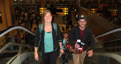 Emma, Stefan and Brian walk upstairs toward their airline departure gate.