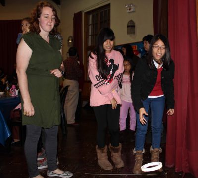 Sierra's host sisters, Maria and Jimena, play a ring toss game.