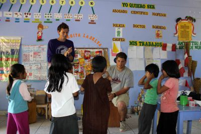 Derek and Michael teach children a song. 