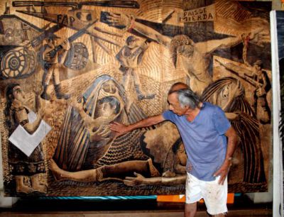 Delfin shows the group a huge wood carving on terror during the times of the Shining Path.