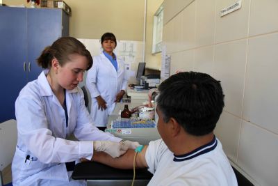 Leah draws a blood sample from Peru SST Service Coordinator Willy Villavicencio.