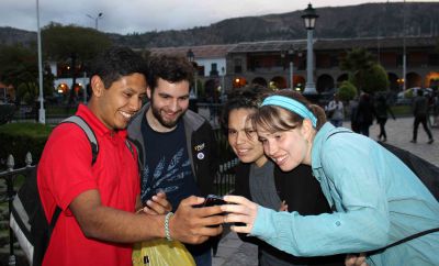 Alejandro shows Andrew, Edith and Leah a photograph he took of a gigantic spider.